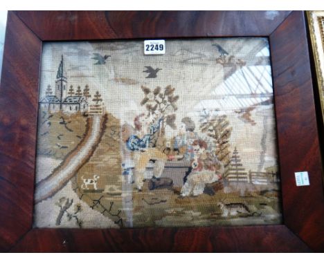 A woolwork picture, late 19th century, depicting children playing with dogs against a church landscape, framed and glazed, 45
