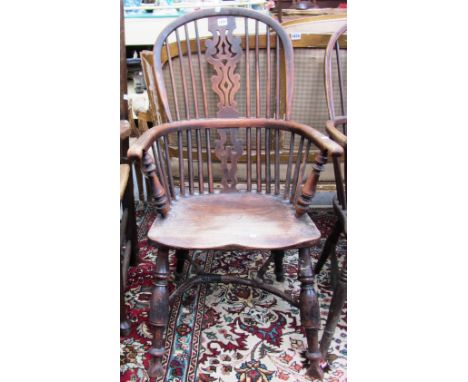 A George III yew, ash and elm stick back Windsor chair with pierced splat and crinoline stretcher on turned supports. 