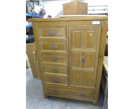 A modern light oak American cabinet having five short drawers, a cupboard revealing two short drawers and a single long drawe