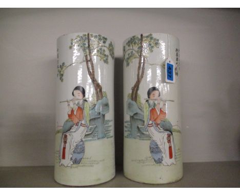 A pair of early 20th century Chinese porcelain vases of cylindrical form, decorated with a woman playing a musical instrument