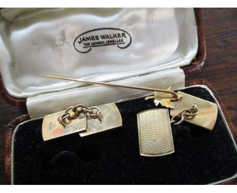 A pair of 9ct gold cuff links, together with a 10ct gold stick pin with maple leaf decoration