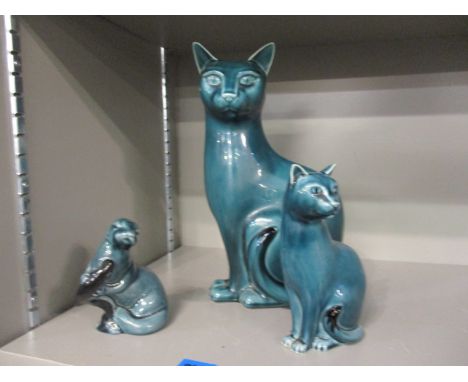Three Poole Pottery green glazed model animals to include two cats and an otter