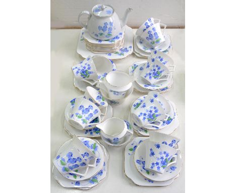 A COLCLOUGH BONE CHINA TEA SERVICE, ART DECO BLUE FLOWERS PATTERN 4117 AND A COLCLOUGH EARTHENWARE TEAPOT AND COVER EN SUITE 