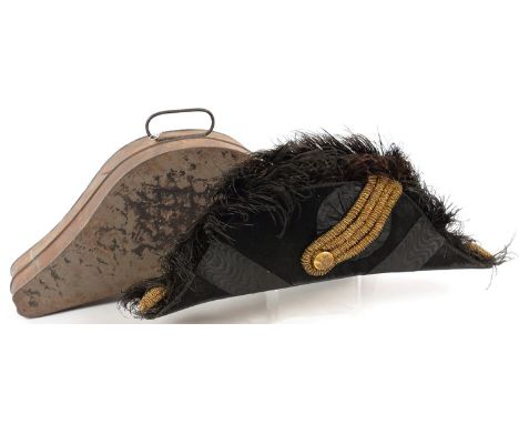 A BLACK OSTRICH FEATHER TRIMMED BICORN HAT, WITH GOLD BRAID AND ROYAL ARMS BUTTON, BY EVENNETT, BUSS AND CO, IN JAPANNED BOX,
