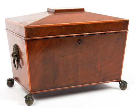 AN EARLY VICTORIAN MAHOGANY AND LINE INLAID TEA CADDY OF SARCOPHAGUS SHAPE, THE FITTED INTERIOR WITH PAIR OF CANISTERS, EMBOS