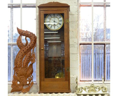 AN OAK CASED WALL CLOCK, THE ENAMEL DIAL INSCRIBED THOS P CARTER RUGBY, 96CM H, A WHITE PAINTED WROUGHT IRON WALL BRACKET AND