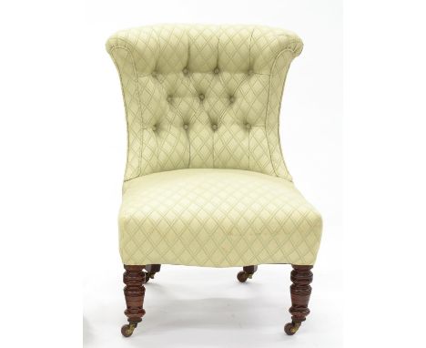 A VICTORIAN MAHOGANY NURSING CHAIR ON TURNED LEGS WITH BUTTON BACK FABRIC 