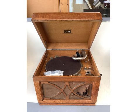 A vintage honey coloured oak case HMV wind up table top gramaphone, and a vintage sewing machine SINGER, hand sewing machine,