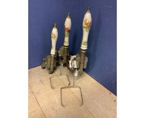 Two Homark draught beer engines and another part with ceramic handles decorated with hunting scenes, and a qty of brass beer 