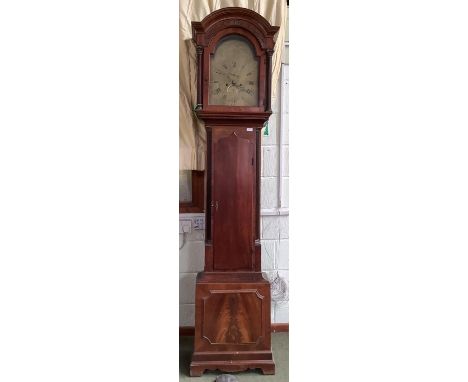 Georgian mahogany longcase clock with embossed brass arched dial, twin winding holes, date apertures and seconds dials.  Skin