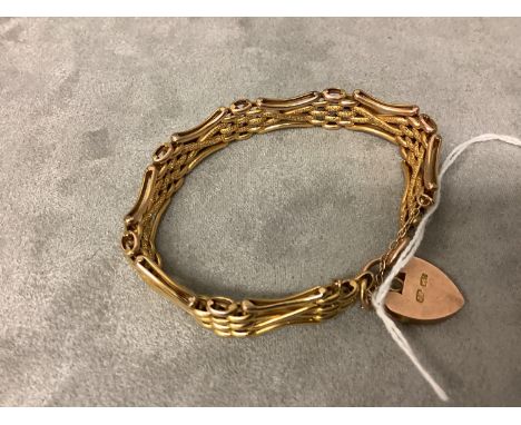 A Yellow four gate bracelet with textured finish to a padlock clasp with safety chain fitting 15 gms. 