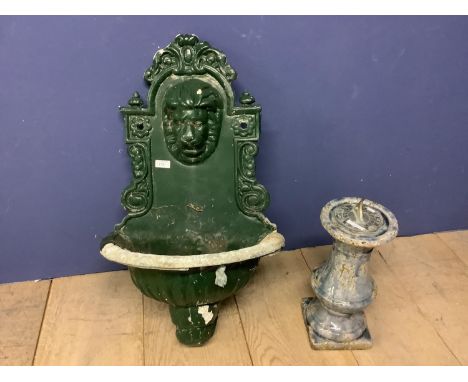 A green painted garden planter with lion finial to back plate, and a sundial, set in a ceramic stand 
