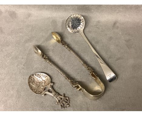 A pair of Aesthetic chased Victorian silver sugar tongs, By Henry Holland London 1877, A Georgian silver sifter ladle, by Ric