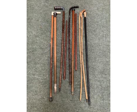 Quantity of walking and other canes; two leather showing canes, yellow metal  banded vintage cane, 2 silver top canes (worn),