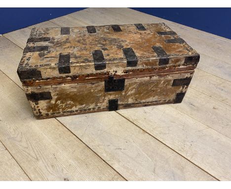 A trunk containing tribal artefacts, including beaded columns, carved wooden stools, tribal masks, and tribal art of seated f