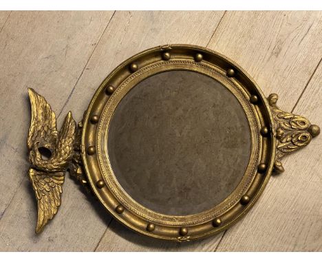 Circular bevelled glass Captains mirror, with eagle finial, 68 x 46cm 