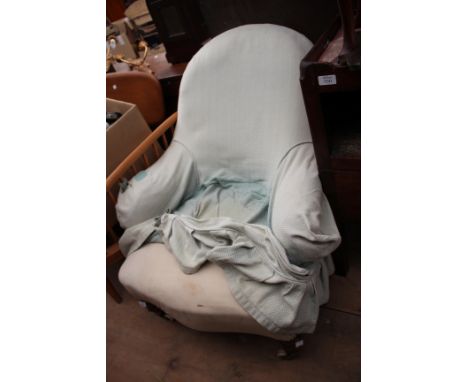 A VICTORIAN LOW ARMCHAIR with turned tapering mahogany legs, terminating in Cope & Collinson brass and ceramic casters, 67cm 