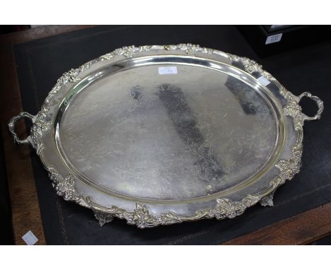 A SILVER PLATED TRAY with scrolling moulded edge together with a quantity of silver plated entree dishes, a silver plated bre