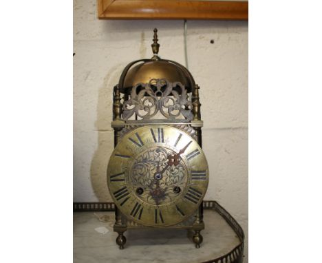 A 17TH CENTURY STYLE BRASS LANTERN CLOCK with Roman chapter ring and foliate scroll engraved centre, twin train movement stri