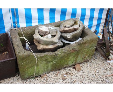 AN ANTIQUE CARVED STONE TROUGH, 92cm wide x 36cm high (AF)