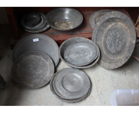 A COLLECTION OF ANTIQUE PEWTER CHARGERS AND PLATES together with a circular tray and two bowls