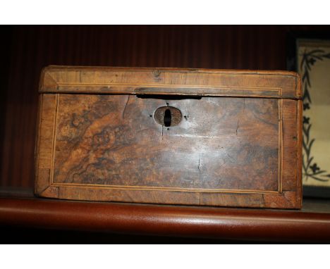 A GEORGIAN WALNUT TEA CADDY with crossbanded decoration (interior lacking), 25.5cm wide 