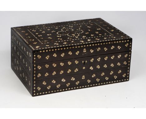 AN ANTIQUE ANGLO-INDIAN EBONY WRITING BOX with carved and ivory inlaid decoration, the lifting lid opening to reveal a tray o