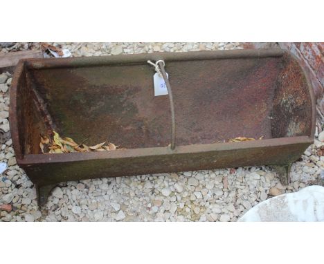 AN OLD CAST IRON FEEDING TROUGH with curved top, 79cm wide