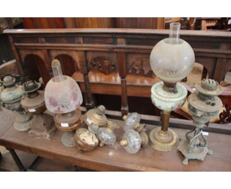 A GROUP OF FIVE OLD OIL LAMPS together with five oil lamp reservoirs 