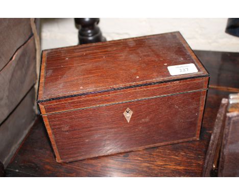 A GEORGE III PARTRIDGE WOOD WALNUT CROSSBANDED AND EBONY STRUNG DECORATED TEA CADDY, two lidded compartments within, 23cm wid