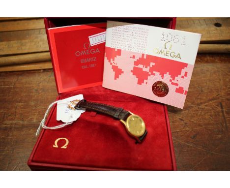 AN OMEGA 'DE VILLE' WRISTWATCH, gilt dial with hour batons and with a leather strap and with original international guarantee