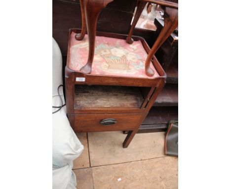 A GEORGE III MAHOGANY TRAY TOP COMMODE with pierced carrying handles, tambour fronted pot cupboard above a drawer beneath, st