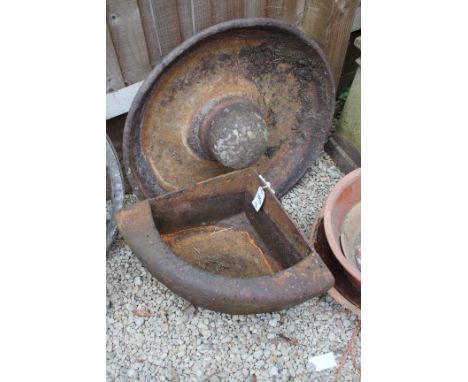 AN OLD CAST IRON CORNER WATER TROUGH, 65cm wide together with a feeding trough, 124cm wide and a circular feeding trough, 74c