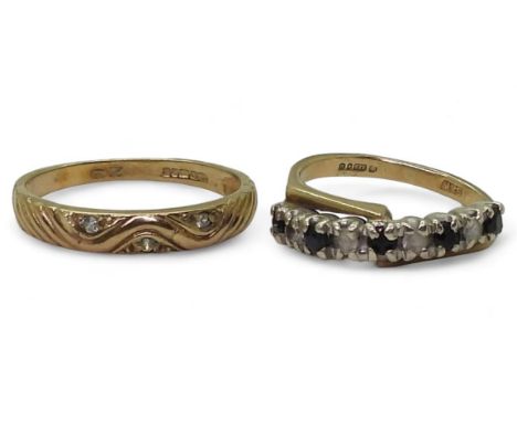 A 9ct gold cz set band ring, size P, together with a 9ct sapphire and clear gem set ring, size K, weight together 4gms Condit
