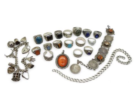 A silver charm bracelet, a First Nation style carnelian pendant and feather ring, silver and white metal gem set rings to inc