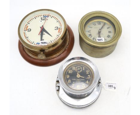 A U.S. Navy Mark I Boat Clock; a Marine Nationale bulkhead clock by J. Auricoste, Paris; and another bulkhead clock, the dial