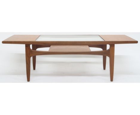 A mid 20th century G Plan teak glass topped coffee table with shaped supports joined by lower tier, 42cm high x 137cm long x 