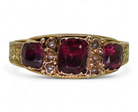 An 18ct gold Victorian garnet and pearl ring, size R, weight 2.1gms Condition Report:Available upon request