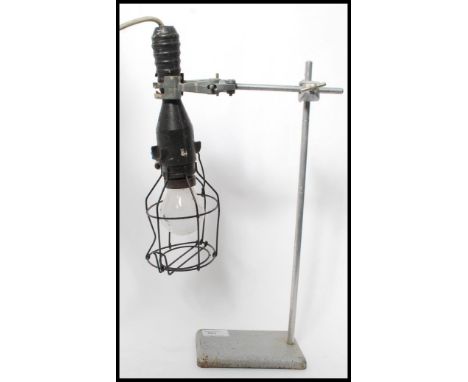 A vintage 20th century retro industrial up-cycled table lamp constructed from a vintage cast metal laboratory adjustable clam