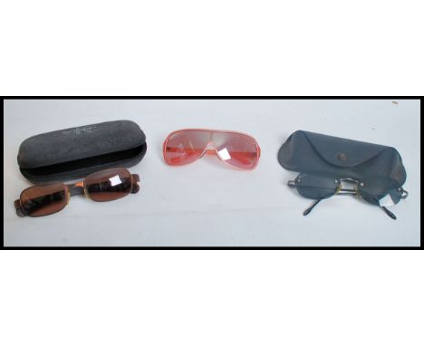 A collection of vintage designer sunglasses to include two pairs of Ray Bans and a pair of Calvin Klein.