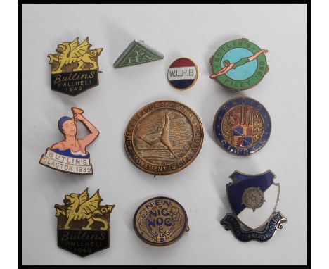 A collection of vintage 20th century enamel badges to include Butlins Clacton 1939, Butlins, Pwllheli 1949 x 2, Butlins Filey