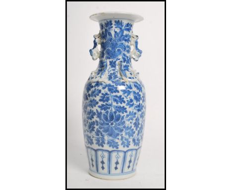 A 19th century Chinese ceramic vase having twin dragon handles and Fu dogs to the neck. The vase having a hand painted floral