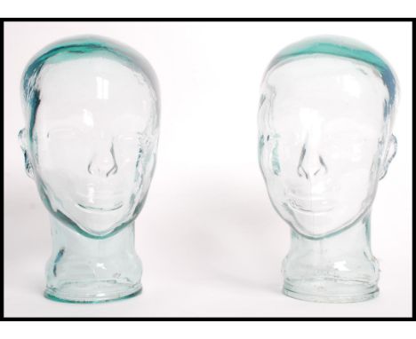 A pair of 20th century moulded pressed glass phrenology type heads - shop display stand / millinery mannequin heads. Moulded 