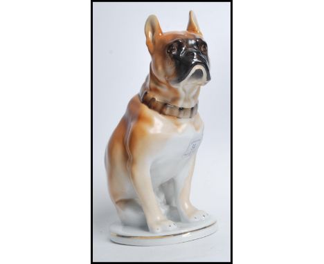A 20th century Russian ceramic boxer dog. The dog sat in an upright position set to a ceramic circular base, stamped tot he u