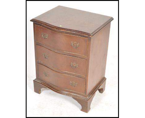 A Georgian revival mahogany bachelors chest of drawers being raised on bracket legs with a series of drawers and flared edge 
