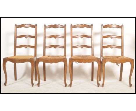 A set of 4 French vintage mid century country oak provincial dining chairs having rattan weave seats raised on&nbsp; turned l