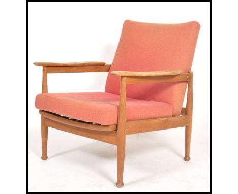 A retro mid century Guy Rogers ' Manhatten ' armchair having show wood angular teak frame with with swept arms with removable