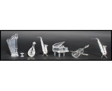 A group of six Swarovski faceted crystal glass musical instruments to include piano and stool, harp , bass, mandolin and two 
