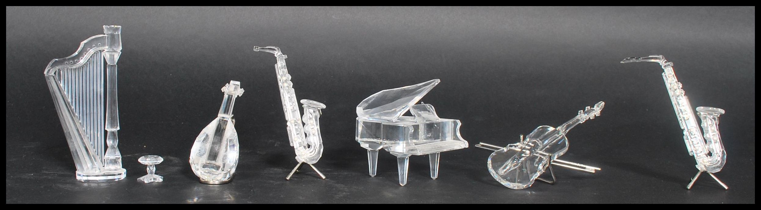 A group of six Swarovski faceted crystal glass musical instruments to