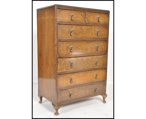 A vintage 20th century Queen Anne revival walnut straight six chest of drawers, raised on stub cabriole legs, swag handles to